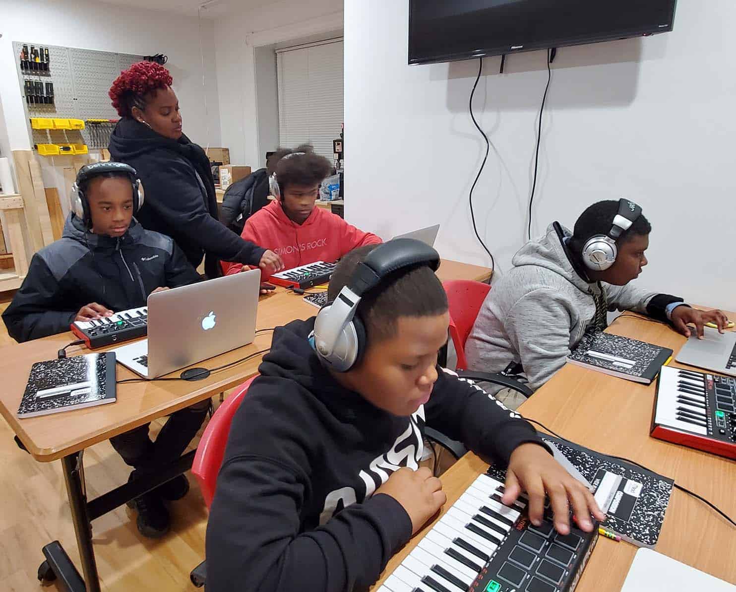 B.P.M. founder working with an all boys cohort as they are sharpening their music production skills